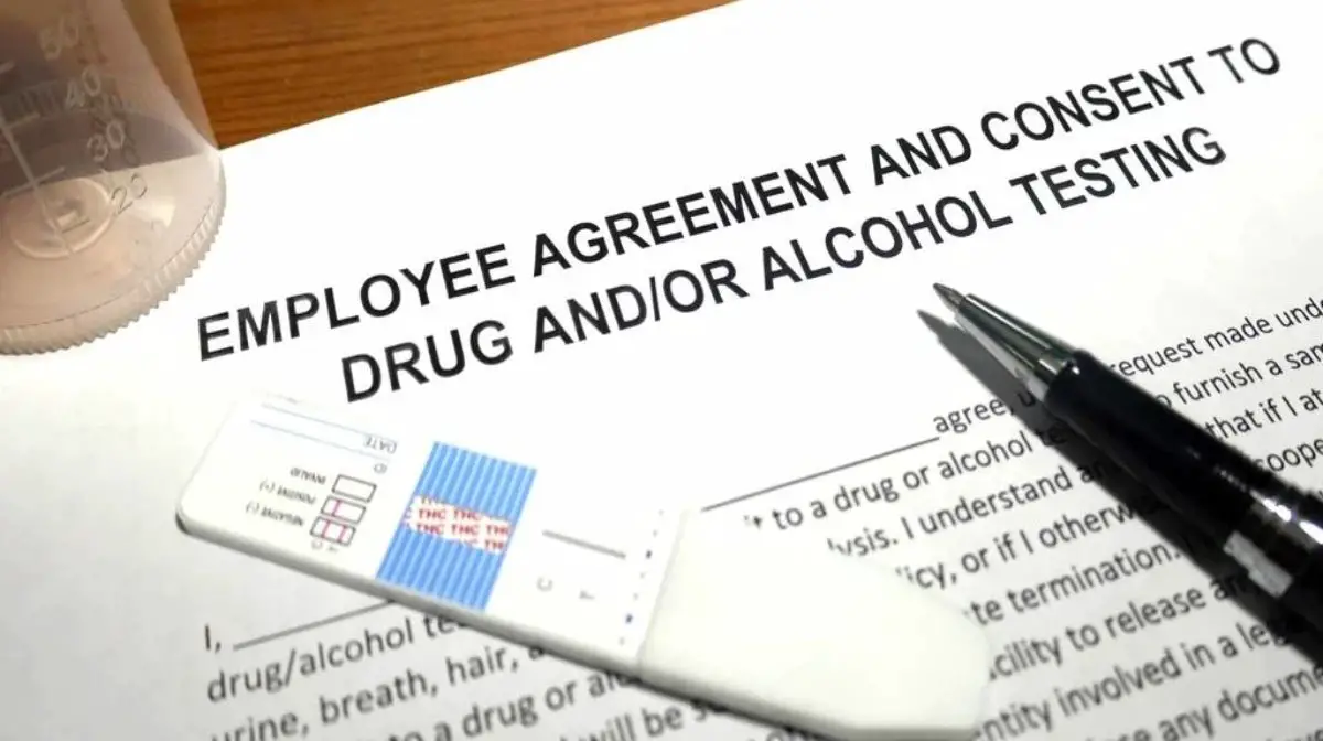 An employee agreement and consent to drug and/or alcohol testing document, a drug testing kit, and a pen. 